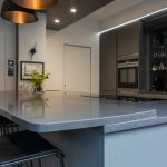 Kitchen Island Extended to accommodate sitting area at a higher level in grey colour Merengo Modern